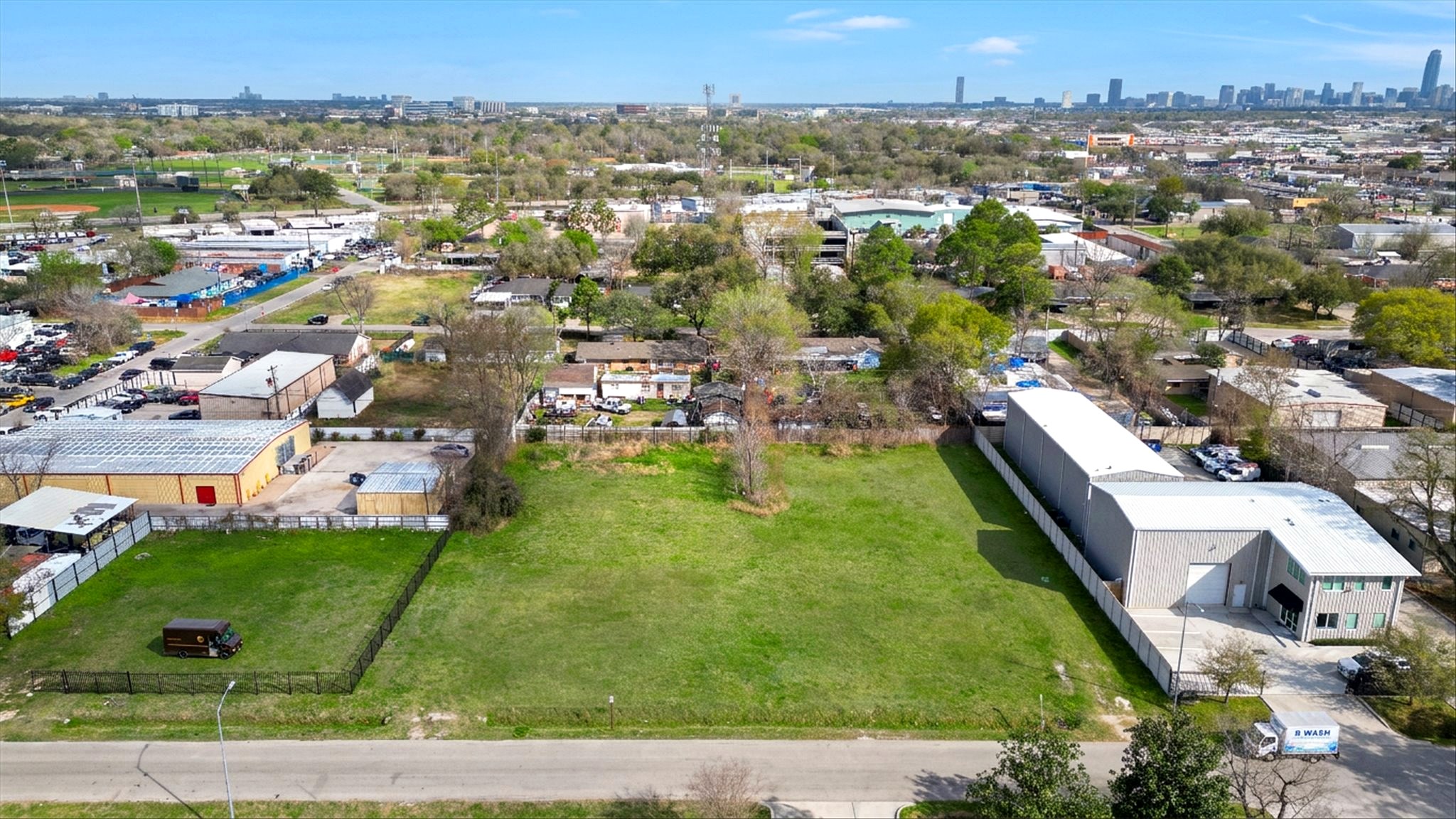 Aerial photograph of 5814 Cypress Street development site showing cleared land with Houston skyline in background