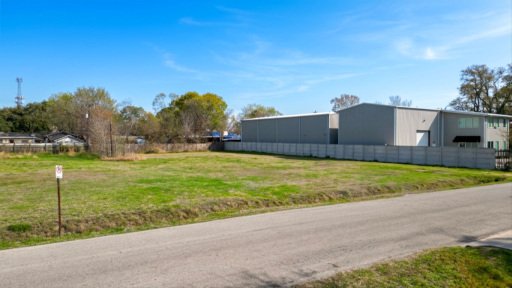 Ground-level view showing site frontage and adjacent building